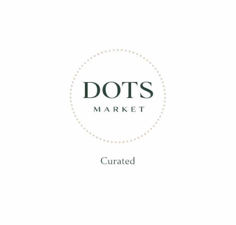 May include: A white background with the text "DOTS MARKET" in a dark green color, encircled by a dotted line. Below the text is the word "Curated" in a smaller font.