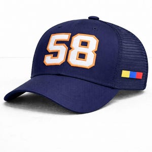 May include: Navy blue trucker hat with the number "58" in white with an orange outline. The hat has a mesh back and a small color block design on the side. A classic baseball cap style.
