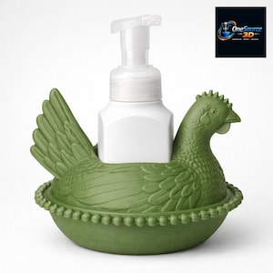 May include: A green chicken-shaped soap dispenser holder with a white soap dispenser. The holder has a detailed design, including feathers and a beaded edge. The dispenser has a white pump.