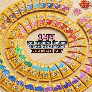 May include: A collection of 144 vibrant colors of 2.6mm mini beads in small yellow packets, arranged in a circular pattern. The packets are labeled "Artkal Beads" and the text "Gigantic Set" is visible.
