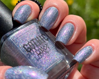 Memento, Holographic Silver With Subtle “Glowing” Purple, Blue and Yellow Shifts Nail Polish