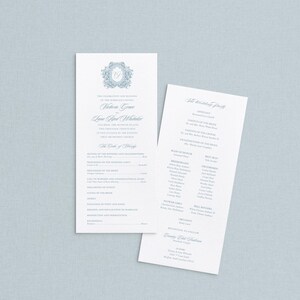 May include: Two white wedding programs with blue text and floral accents. The programs list the wedding party, order of events, and names. The background is a light blue color.