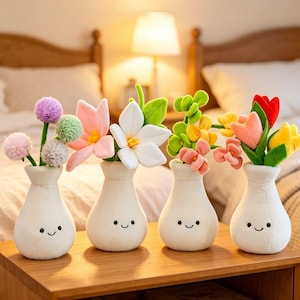 May include: Four white plush vases with smiling faces, each holding a different arrangement of colourful plush flowers. The flowers include pink, white, yellow, red, and green, creating a cheerful display.