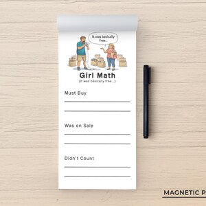 May include: A white magnetic notepad featuring a cartoon illustration of two people with shopping bags and the text Girl Math (It was basically free...). The pad includes sections labeled Must Buy, Was on Sale, and Didn't Count with lines for writing, accompanied by a black pen.