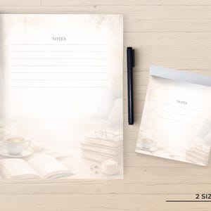 May include: Two rectangular note pads with lined paper featuring a soft, light-toned background image of a coffee cup, an open book, a stack of books, and a candle. A black pen is positioned between the two pads, and the text 2 SIZES is visible.