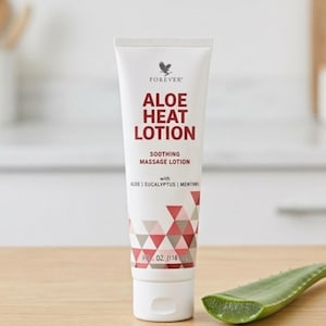May include: A white tube of Aloe Heat Lotion with red text and a geometric design. The tube is labeled "Forever" and "Soothing Massage Lotion." An aloe vera leaf is next to the tube. The tube contains 116 ml of lotion.