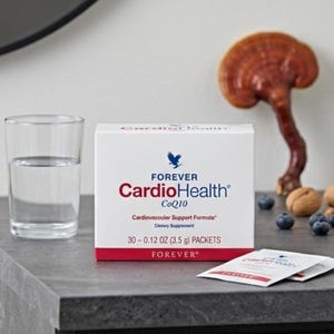 May include: A white box of "Forever CardioHealth CoQ10" dietary supplement with a red stripe, a glass of water, and a mushroom. The box contains 30 packets, each 3.5 g.