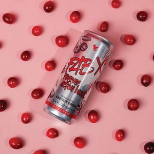 May include: A silver energy drink can with red and white text, surrounded by red berries on a pink background. The can reads "FAB X Forever active boost" and "Zero Sugar Energy Drink 250 ml".