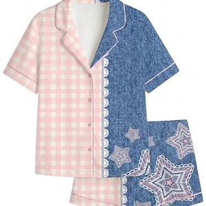 May include: A two-piece pajama set. The top is half pink gingham and half denim-look with white lace trim. The shorts are denim-look with star and lace designs. The set has a button-down shirt with short sleeves.