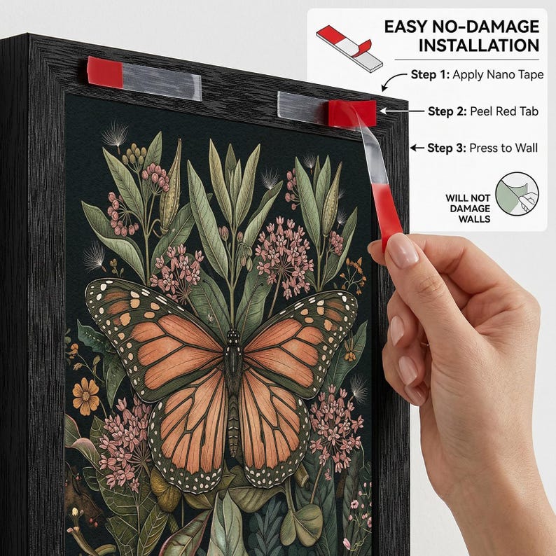 May include: A framed art print featuring a monarch butterfly with orange and black wings, surrounded by green foliage and pink flowers. The frame is black. The image shows the steps for easy, no-damage installation using nano tape.