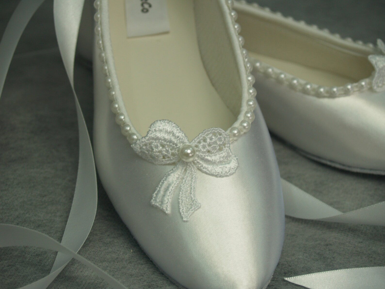 white satin ballet shoes with ribbon