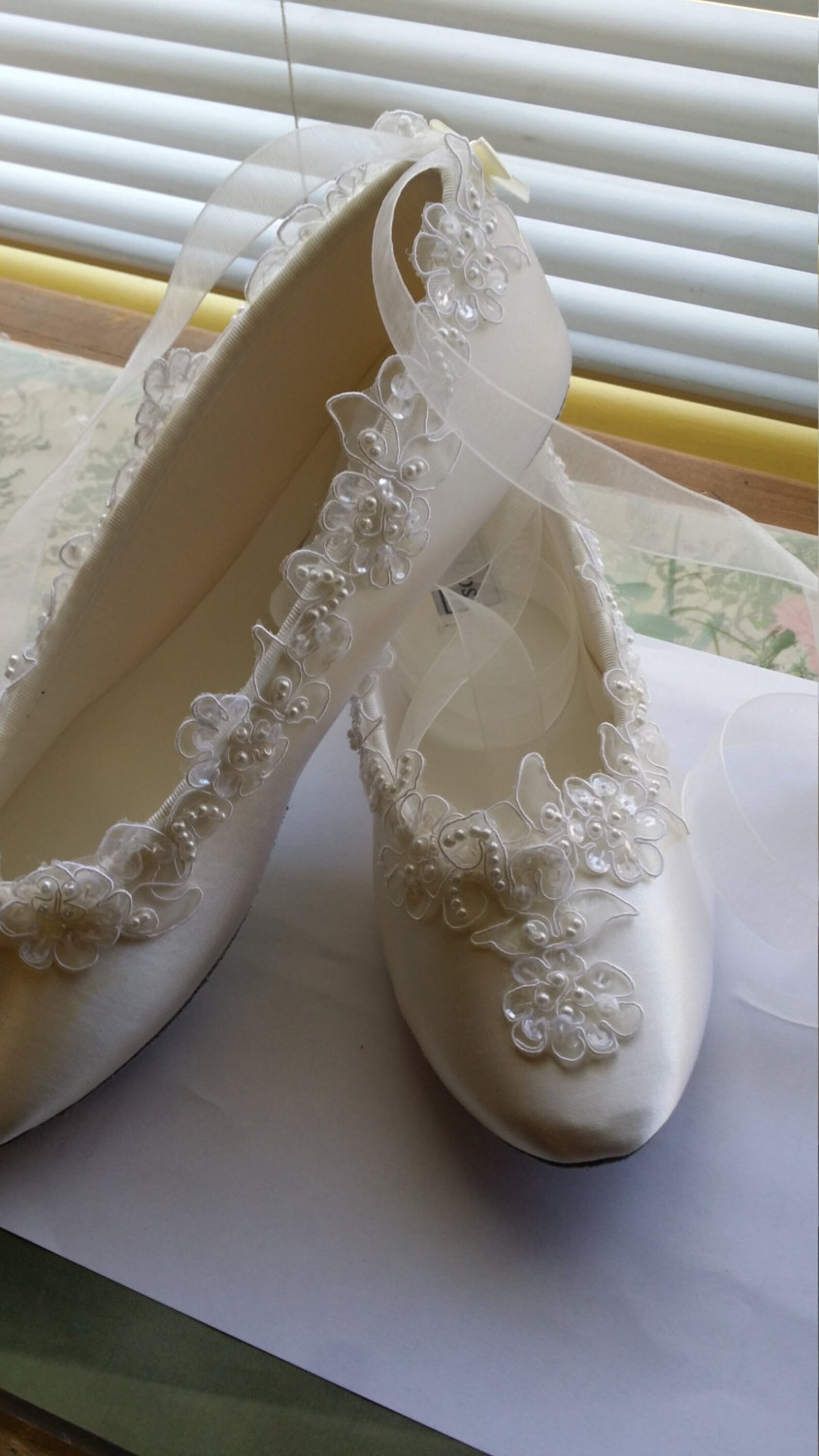 brides satin wedding flats white silver edging appliqué, white satin ballet style slippers, lace flowers all along edge. romanti