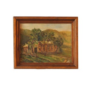 May include: Oil painting of a rural scene featuring a house and outbuilding, framed in a dark wood. The house is brown with a dark roof, surrounded by green trees and a fence. The background shows rolling hills.