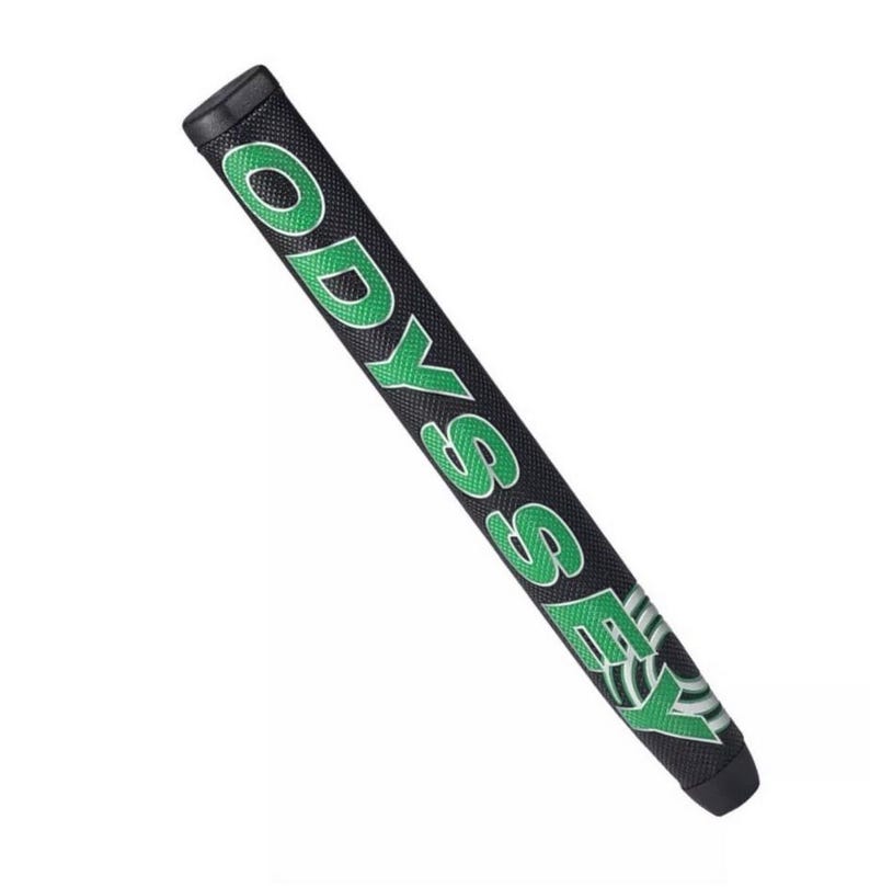 May include: Black golf putter grip with the word "ODYSSEY" in green block letters. The grip has a textured surface and a black end cap. The word "ODYSSEY" is repeated on the grip.