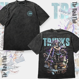 May include: Two charcoal gray t-shirts. One features a teal logo on the chest. The other displays a graphic of a character with the word "TRUNKS" in teal and the word "Future" below the character.