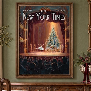 May include: A framed print of a New York Times cover dated Sept. 16, 1987, featuring a painting of a ballerina dancing on a theater stage in front of a large, illuminated Christmas tree, with a dark audience visible in the foreground.