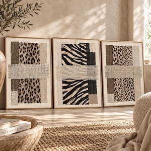 May include: A set of three rectangular framed wall art pieces featuring mixed media collage elements. Each piece displays vertical panels of leopard print, zebra print, and textured beige fabric, overlaid with a horizontal strip of woven burlap.