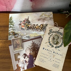 May include: A vintage postcard with a winter scene of a horse-drawn carriage with people riding in it. The postcard is on a wooden surface with a smaller photo of a woman holding two small dogs. There is a small photo of a man with a beard and a gold chain with a small photo of Jesus on it. The postcard has the text "Joy Public School District No. 92 Paddock Twp., Holt Co., Nebraska. R. H. Weekly, Teacher. O. E. Ott, Director. E. F. Roberts, Treasurer. J. Johnson, Moderator."