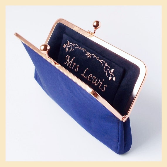 navy and rose gold clutch bag