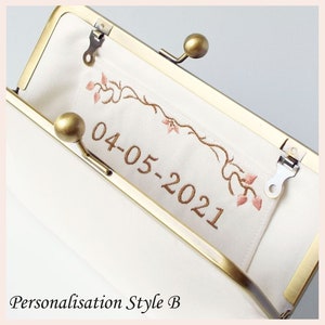 example of personalised date in bronze lettering with floral border in bronze and rose pink threads embroidered onto interior slip pocket of handmade clutch bag