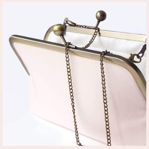 pale pink wedding clutch bag with Antique Brass tone kisslock frame and chain has white lining