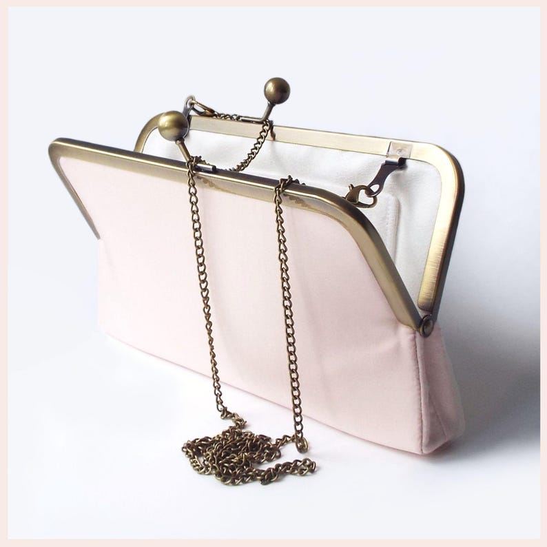 pale pink wedding clutch bag with Antique Brass tone kisslock frame and shoulder chain has white lining