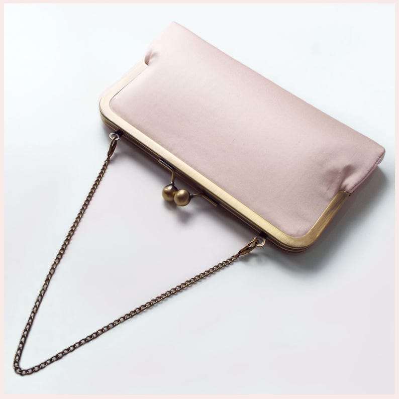 pale pink evening clutch bag with Antique Brass tone kisslock frame and chain handle