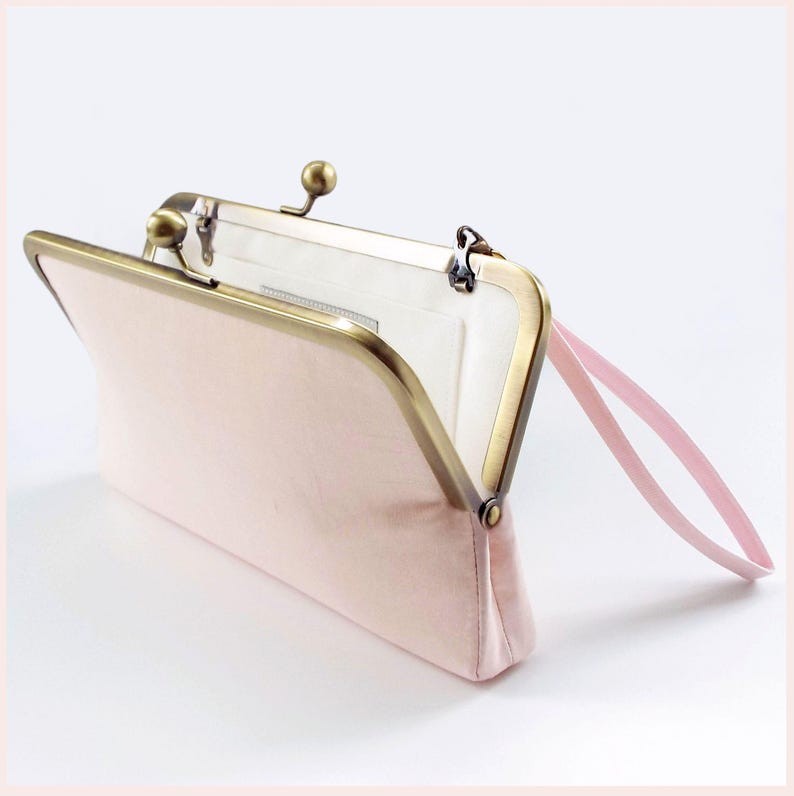 pale pink wedding clutch bag with Antique Brass tone kisslock frame and wristlet has white lining