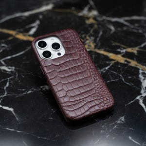 May include: A set of three ceramic mugs with a speckled, matte finish. The mugs are in shades of cream, light gray, and dark gray. Each mug has a simple, minimalist design and a rounded handle.