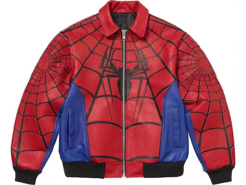 May include: Red leather jacket with a black spiderweb design on the sleeves and back, and a large spider emblem on the chest. Features blue panels on the sides and a black collar, cuffs, and hem. The jacket has a zipper closure.