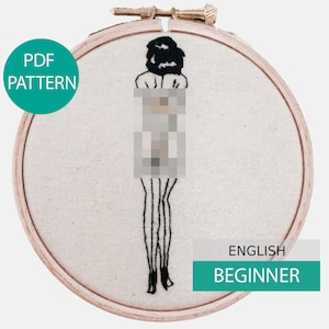 May include: Black and white embroidery of a person in a hoop. The embroidery is on a beige fabric. The hoop is made of wood. The text "PDF PATTERN" is on a teal circle. The text "ENGLISH BEGINNER" is on a teal rectangle.