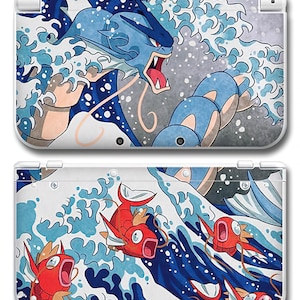 May include: A white Nintendo 3DS case featuring a vibrant illustration of a blue dragon-like creature and red fish in a wave pattern. The design is inspired by Japanese art, with a dynamic composition and bold colors.