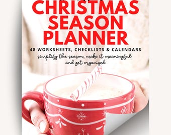 May include: A red and white Christmas Season Planner with the text "The Essential CHRISTMAS SEASON PLANNER". The planner includes 48 worksheets, checklists, and calendars. A red mug with snowflakes and a candy cane is in the foreground.