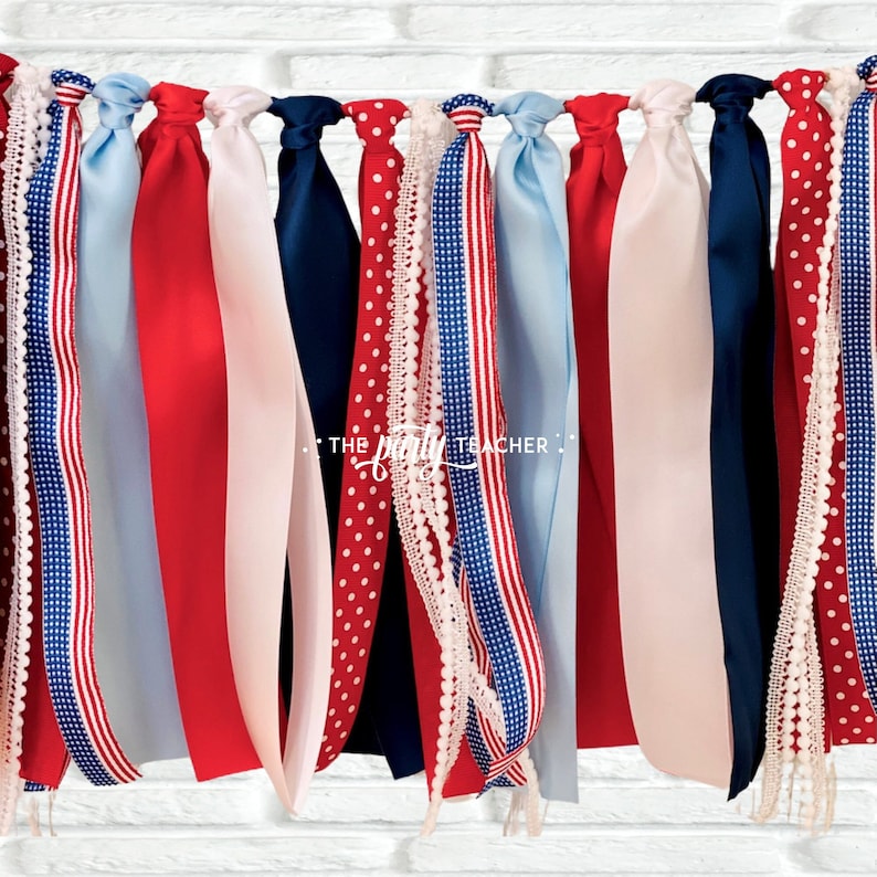 May include: A red, white, and blue ribbon garland with various patterns, including polka dots, stripes, and lace. The garland is perfect for a patriotic celebration.
