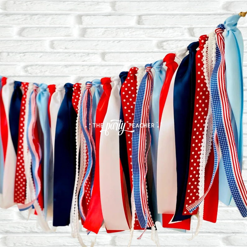 May include: Red, white, and blue ribbon banner with a white background. The banner has a variety of patterns including polka dots, stripes, and lace. The text "THE party TEACHER" is visible on the banner.