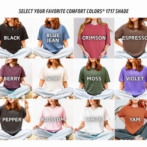 May include: A selection of short-sleeved t-shirts in various colors, including black, blue jean, crimson, and espresso. Each shirt displays a different color name in white text. The text "SELECT YOUR FAVORITE COMFORT COLORS&reg; 1717 SHADE" is at the top.