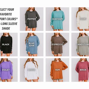May include: A selection of long-sleeve shirts in various colors, including black, blue, and white. The image displays the Comfort Colors 6014 Long Sleeve Shade collection, with each shirt labeled with its color name. The text "SELECT YOUR FAVORITE COMFORT COLORS&reg;" is at the top.