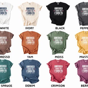 May include: A collection of short-sleeved t-shirts in various colors, each featuring the text "AMERICA TURNS 250 I TURN 90" with a patriotic design. Colors include white, ivory, black, pepper, espresso, yam, moss, mustard, blue spruce, denim, crimson, and berry.
