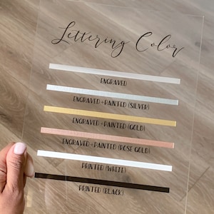 May include: A clear acrylic sign displaying "Lettering Color" in elegant script. Below, color options are shown: Engraved, Engraved + Painted (Silver), Engraved + Painted (Gold), Engraved + Painted (Rose Gold), Printed (White), and Printed (Black).