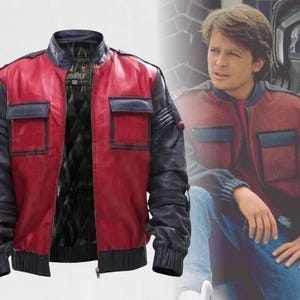 May include: A red and black leather jacket with a quilted black lining. The jacket has two square pockets on the chest and a zipper closure. The sleeves are black with ribbed cuffs. The jacket is inspired by the movie "Back to the Future".