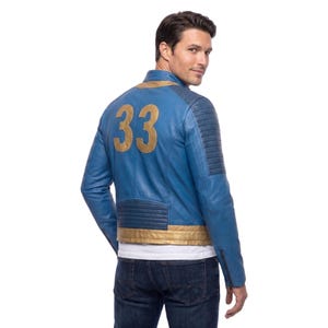 May include: A blue leather jacket featuring a gold number 33 on the back, a stand-up collar, and ribbed detailing on the shoulders and lower back. The jacket includes a gold horizontal band at the waist and long sleeves with zippered cuffs.