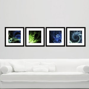 May include: Four black framed abstract art prints with green and blue swirling designs. The prints are hanging on a white wall above a white couch.