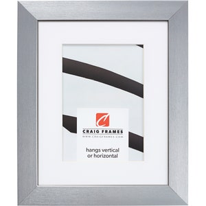 May include: A silver picture frame with a white mat and a white background. The frame is made of metal and has a brushed finish. The frame is designed to hang vertically or horizontally. The text "Craig Frames" and "www.craigframes.com" is printed on the mat.