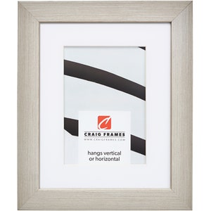 May include: A light gray wood picture frame with a white mat and a white background. The frame is designed to hang vertically or horizontally. The frame has a small label with the text "Craig Frames" and the website address "www.craigframes.com".