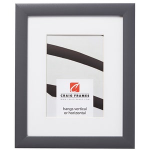 May include: A gray picture frame with a white mat and a white backing board. The frame is made of wood and has a simple design. The frame is 8x10 inches and can be hung vertically or horizontally. The frame is made by Craig Frames.