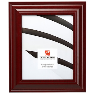 May include: A mahogany wood picture frame with a simple, classic design. The frame is ready to hang vertically or horizontally. It features a subtle wood grain pattern and a smooth finish.