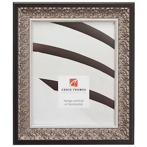 May include: Black picture frame with a silver ornate border. The frame has a white mat and hangs vertically or horizontally. The frame is made by Craig Frames.