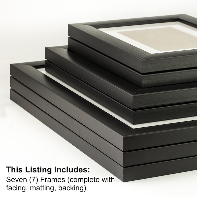 May include: Seven black picture frames stacked on top of each other. The frames are complete with facing, matting, and backing.