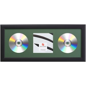 May include: Black frame with a green mat and two CD-sized openings. The frame is designed to hold two CDs or DVDs. The frame can be hung vertically or horizontally. "Hangs vertical or horizontal" is printed on the frame.