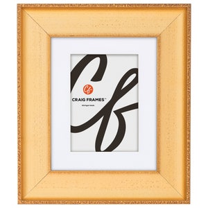 May include: A gold picture frame with a white mat and a small white label with the text "CRAIG FRAMES™ Michigan Made".